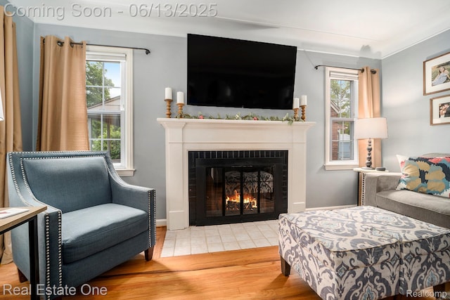 122 N Wilson Ave, Royal Oak, MI 48067 - living area with wood finished floors, a fireplace with flush hearth, and healthy amount of natural light