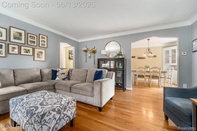 122 N Wilson Ave, Royal Oak, MI 48067 - living room with arched walkways, a chandelier, and light wood-style floors