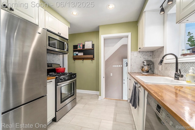 122 N Wilson Ave, Royal Oak, MI 48067 - kitchen with appliances with stainless steel finishes, butcher block countertops, white cabinets, and tasteful backsplash