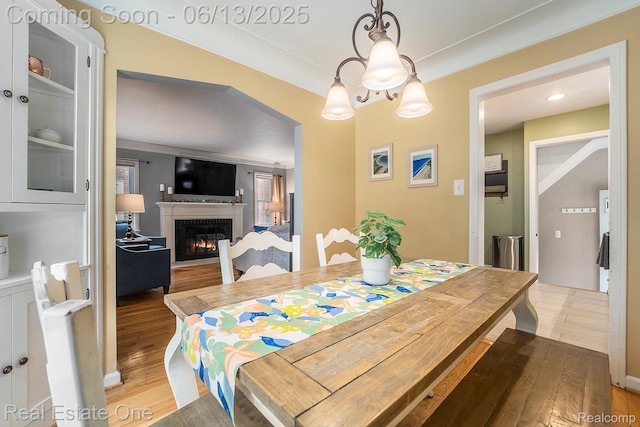 122 N Wilson Ave, Royal Oak, MI 48067 - dining room featuring wood finished floors and a lit fireplace