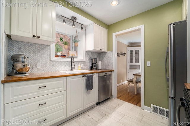122 N Wilson Ave, Royal Oak, MI 48067 - kitchen featuring stainless steel appliances, wooden counters, and white cabinetry