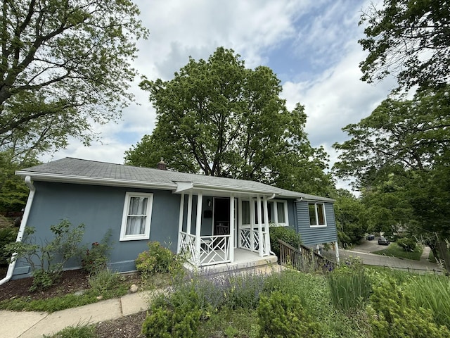 601 Cressfield Ln, Ann Arbor, MI 48103 - view of front of house with covered porch, stucco siding, and a shingled roof