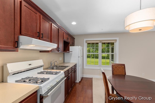 971 Aberdeen Way, Hudsonville, MI 49426 - kitchen featuring white appliances, under cabinet range hood, dark wood-style flooring, recessed lighting, and hanging light fixtures