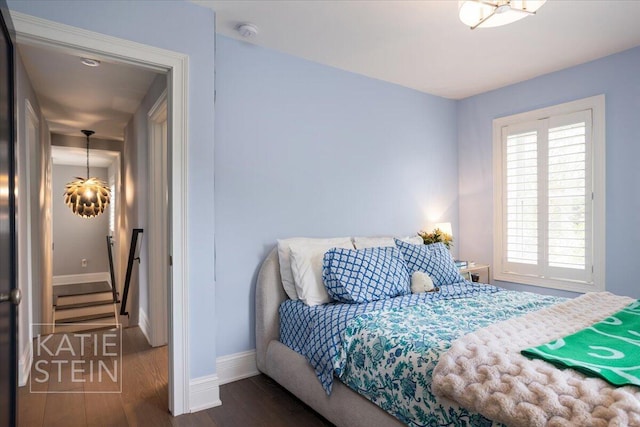 1110 Breton Rd SE, East Grand Rapids, MI 49506 - bedroom featuring wood finished floors and a chandelier