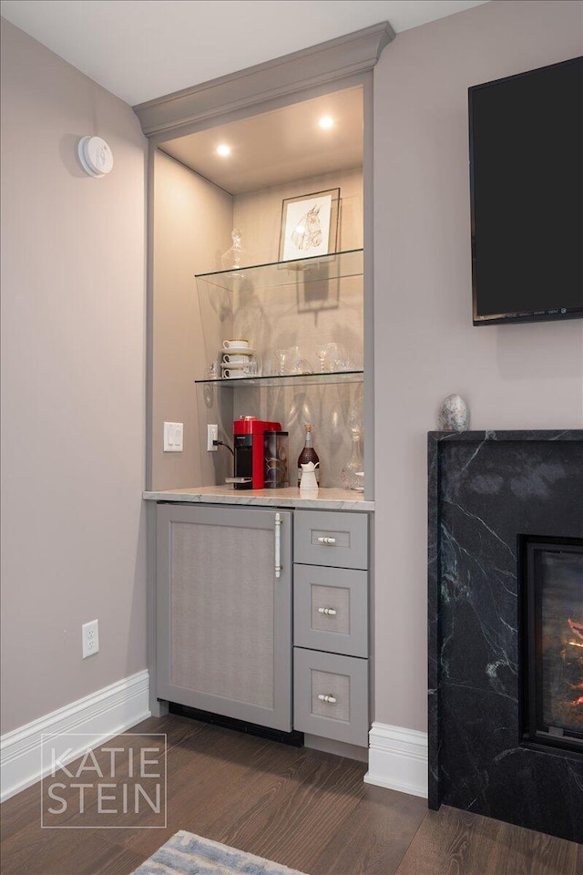 1110 Breton Rd SE, East Grand Rapids, MI 49506 - indoor bar featuring dark wood-style floors and baseboards