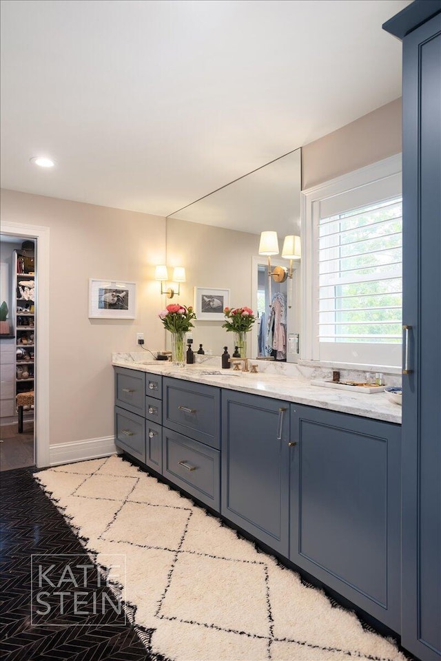 1110 Breton Rd SE, East Grand Rapids, MI 49506 - bathroom with double vanity, recessed lighting, and a spacious closet