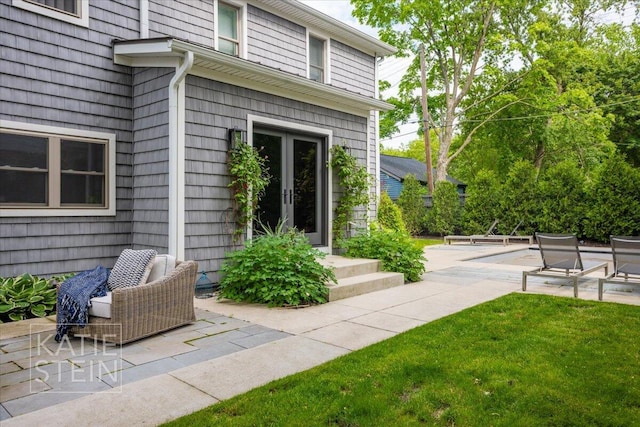 1110 Breton Rd SE, East Grand Rapids, MI 49506 - entrance to property featuring a patio area and a lawn