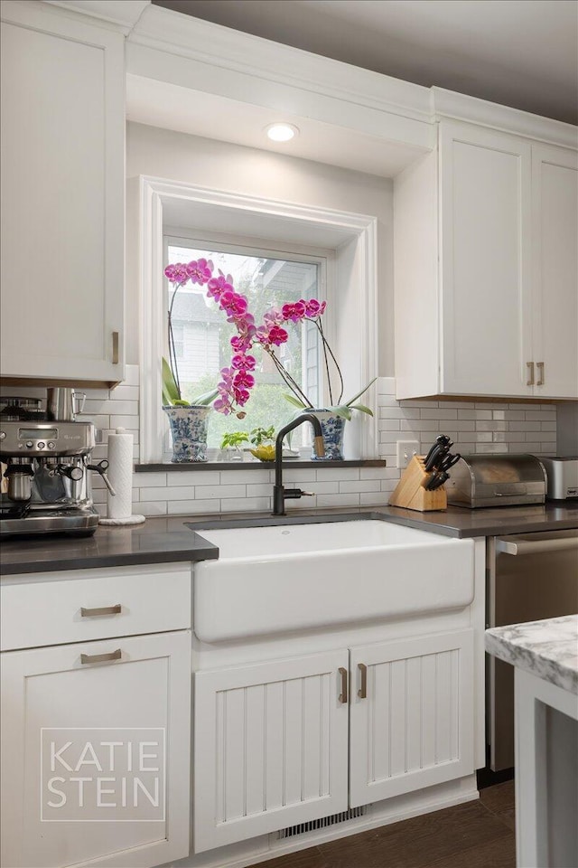 1110 Breton Rd SE, East Grand Rapids, MI 49506 - kitchen with backsplash, white cabinetry, dark countertops, recessed lighting, and dishwasher