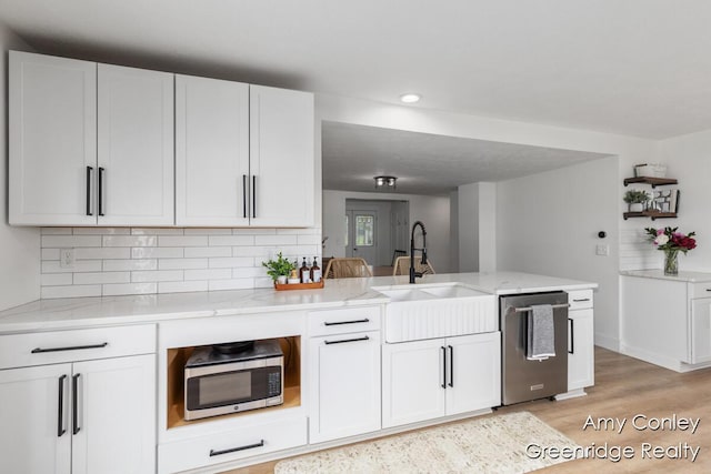 821 W Baseline Rd, Plainwell, MI 49080 - kitchen featuring appliances with stainless steel finishes, light wood-style floors, recessed lighting, white cabinetry, and light stone counters