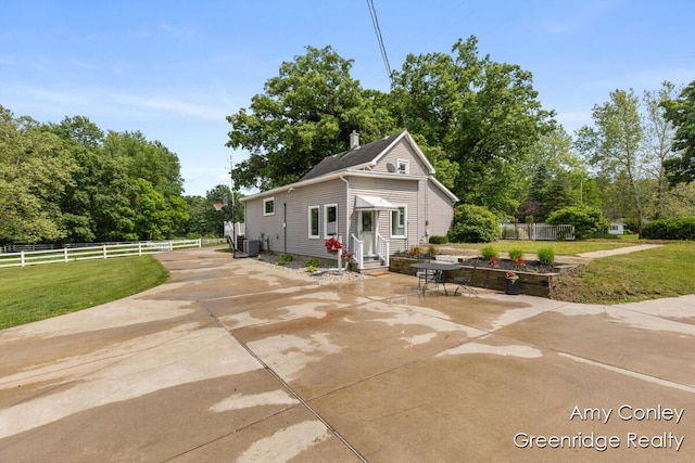821 W Baseline Rd, Plainwell, MI 49080 - view of front facade featuring a patio area, entry steps, and view of wooded area