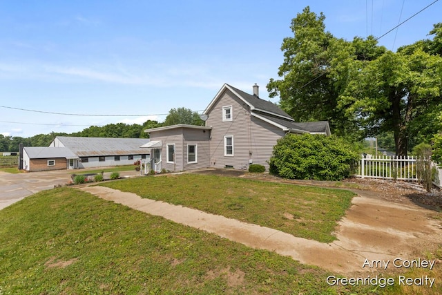 821 W Baseline Rd, Plainwell, MI 49080 - view of front facade with a chimney and concrete driveway