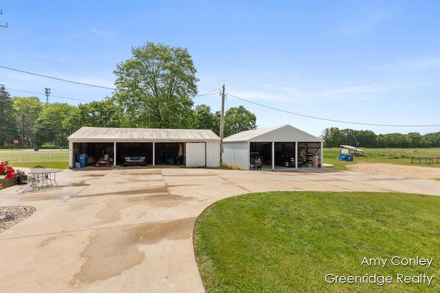 821 W Baseline Rd, Plainwell, MI 49080 - garage featuring a carport and driveway