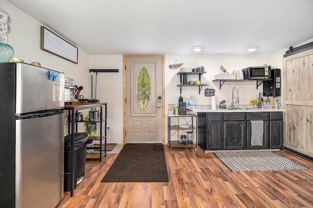 5729 N Bass Lake Rd, Irons, MI 49644 - entryway with a barn door and light wood-type flooring