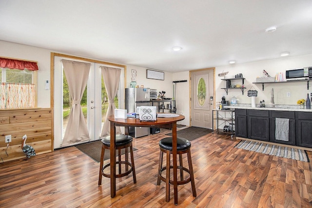 5729 N Bass Lake Rd, Irons, MI 49644 - dining space with wood finished floors and wet bar