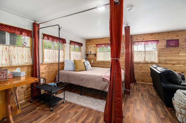 5729 N Bass Lake Rd, Irons, MI 49644 - bedroom featuring wood walls, multiple windows, and wood finished floors