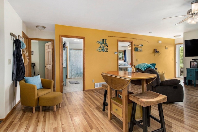 5729 N Bass Lake Rd, Irons, MI 49644 - dining area with a ceiling fan and light wood finished floors