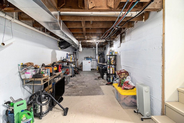5729 N Bass Lake Rd, Irons, MI 49644 - unfinished basement featuring radiator heating unit