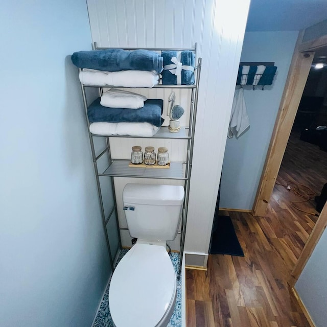 5729 N Bass Lake Rd, Irons, MI 49644 - bathroom featuring wood finished floors and toilet