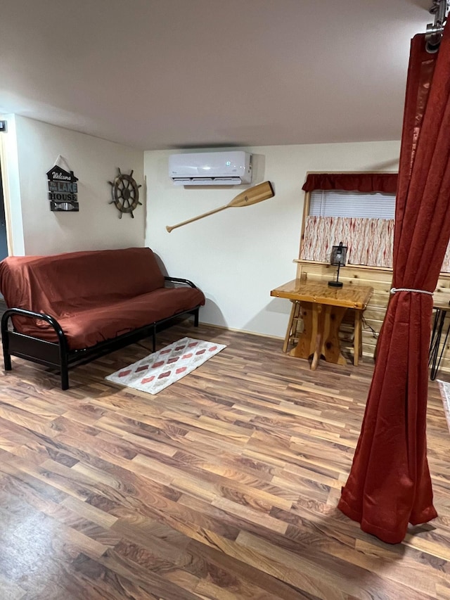 5729 N Bass Lake Rd, Irons, MI 49644 - living area with a wall mounted air conditioner and wood finished floors