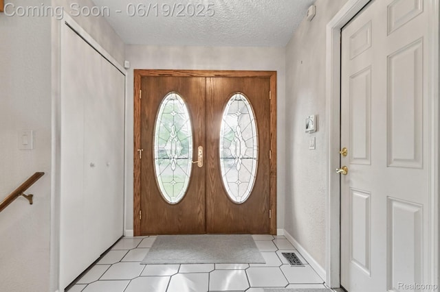39502 Salvatore Dr, Sterling Heights, MI 48313 - foyer entrance with a textured ceiling and light tile patterned floors