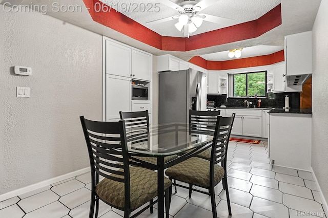 39502 Salvatore Dr, Sterling Heights, MI 48313 - kitchen featuring a textured wall, stainless steel appliances, decorative backsplash, dark countertops, and ceiling fan