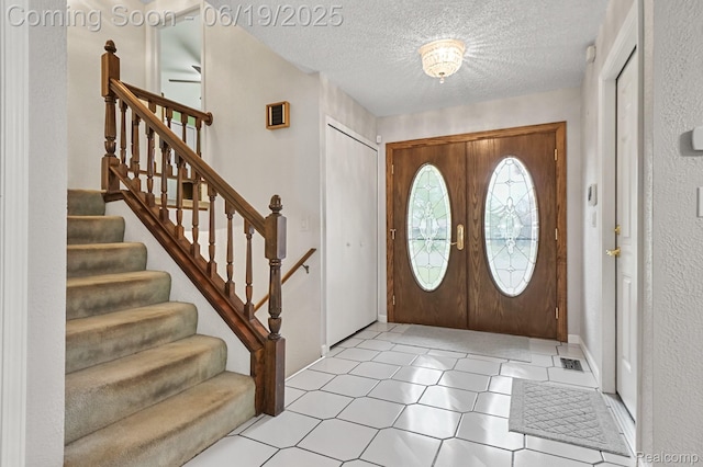 39502 Salvatore Dr, Sterling Heights, MI 48313 - foyer entrance featuring stairway and a textured ceiling