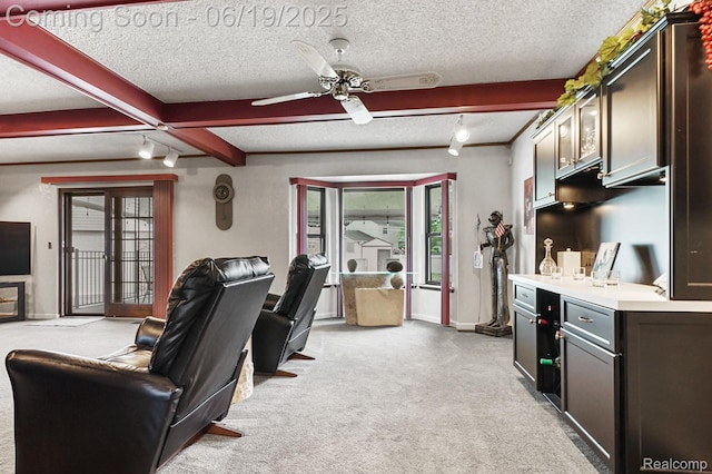 39502 Salvatore Dr, Sterling Heights, MI 48313 - living area featuring light carpet, plenty of natural light, track lighting, a ceiling fan, and a textured ceiling