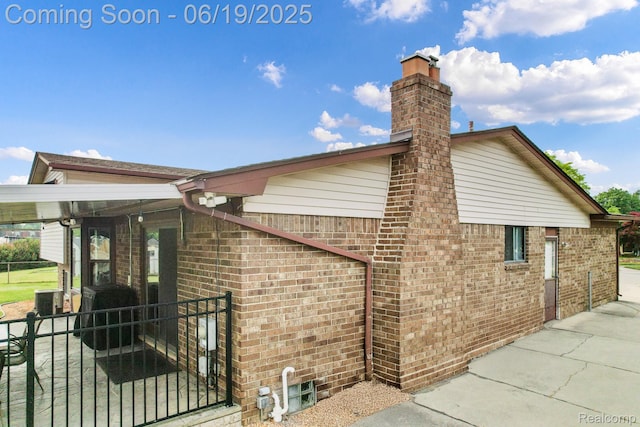 39502 Salvatore Dr, Sterling Heights, MI 48313 - view of home's exterior with brick siding and a chimney