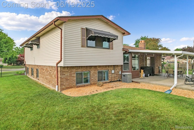 39502 Salvatore Dr, Sterling Heights, MI 48313 - rear view of house with brick siding and a patio area