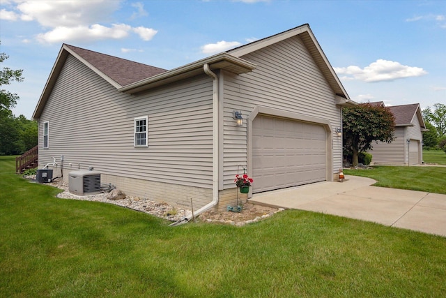 340 E 4th St, Onsted, MI 49265 - view of side of home featuring concrete driveway, a garage, and a lawn