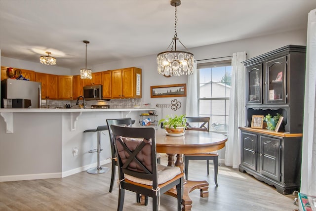 340 E 4th St, Onsted, MI 49265 - dining room featuring a chandelier and light wood finished floors