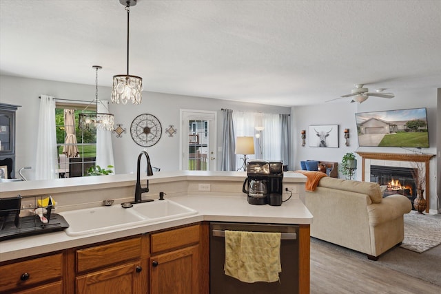340 E 4th St, Onsted, MI 49265 - kitchen with dishwasher, open floor plan, a fireplace, brown cabinets, and light countertops