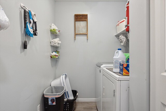 340 E 4th St, Onsted, MI 49265 - washroom featuring washing machine and dryer and wood finished floors