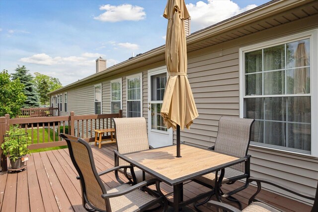 340 E 4th St, Onsted, MI 49265 - wooden deck featuring outdoor dining area