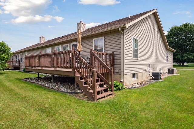 340 E 4th St, Onsted, MI 49265 - back of property featuring a deck, a yard, and a chimney