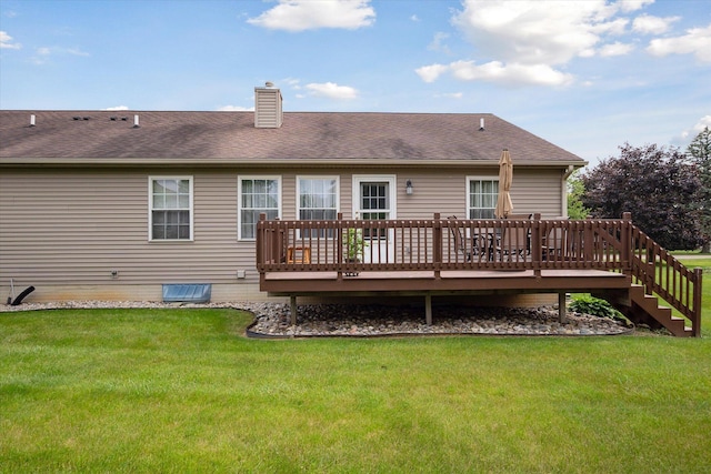 340 E 4th St, Onsted, MI 49265 - back of property featuring a chimney, a wooden deck, a yard, and roof with shingles