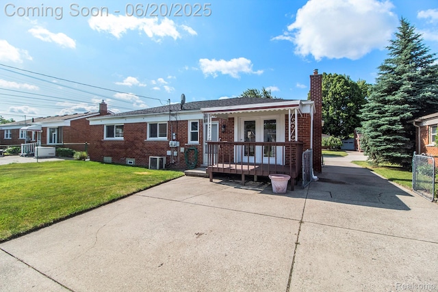 29424 Oakley St, Livonia, MI 48154 - view of front facade with a chimney, brick siding, a front yard, and french doors