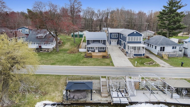 144 E Hickory Rd, Battle Creek, MI 49017 - rear view of property with a metal roof, boat lift, and a residential view