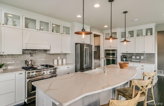 6216 Marsh, Ypsilanti, MI 48197 - kitchen featuring high end appliances, backsplash, an island with sink, recessed lighting, and white cabinets
