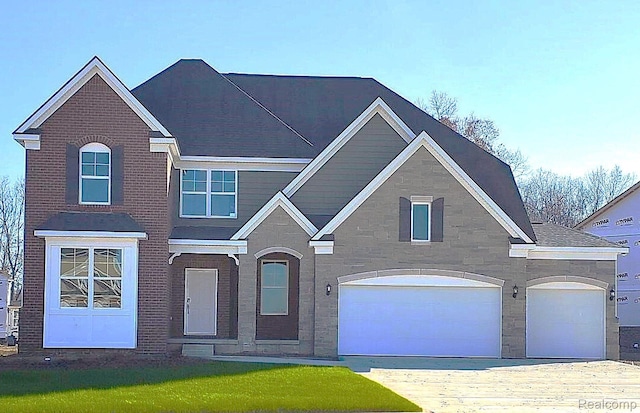 6216 Marsh, Ypsilanti, MI 48197 - traditional home with driveway, stone siding, and an attached garage