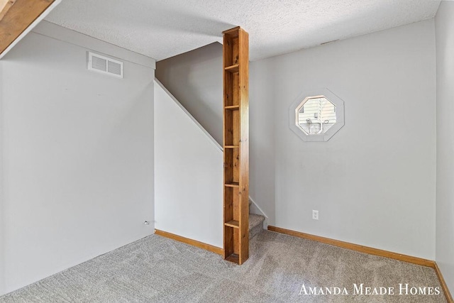 443 Nicholson St, Ionia, MI 48846 - basement featuring stairway, carpet flooring, and a textured ceiling