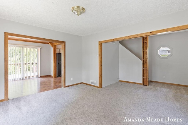 443 Nicholson St, Ionia, MI 48846 - unfurnished room featuring carpet floors, healthy amount of natural light, and a textured ceiling