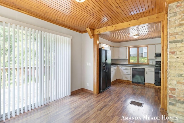 443 Nicholson St, Ionia, MI 48846 - kitchen featuring black appliances, white cabinetry, dark wood-style floors, dark countertops, and a wooden ceiling with exposed beams