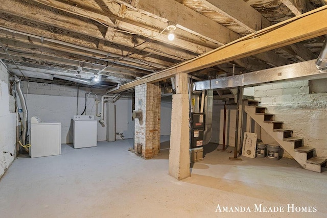 443 Nicholson St, Ionia, MI 48846 - unfinished below grade area featuring washing machine and clothes dryer, stairway, and heating unit
