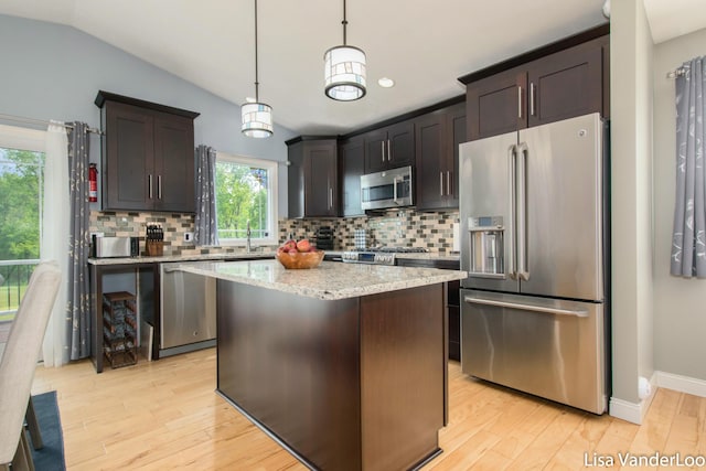 1706 Steff Ct SW, Wyoming, MI 49519 - kitchen with appliances with stainless steel finishes, backsplash, light wood-type flooring, dark brown cabinets, and lofted ceiling