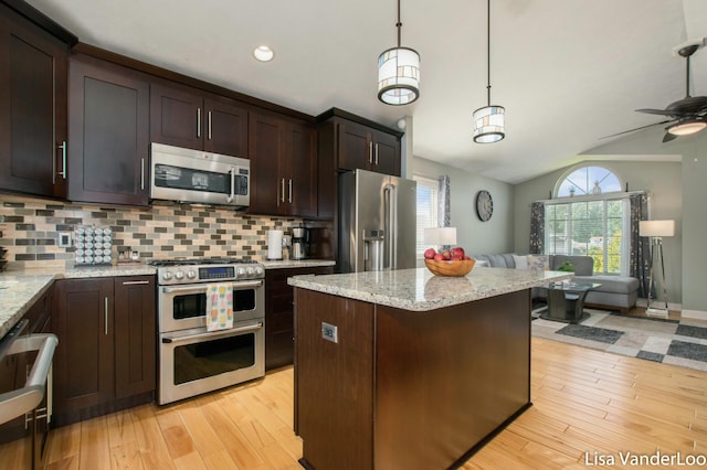 1706 Steff Ct SW, Wyoming, MI 49519 - kitchen with appliances with stainless steel finishes, vaulted ceiling, open floor plan, tasteful backsplash, and light wood-type flooring