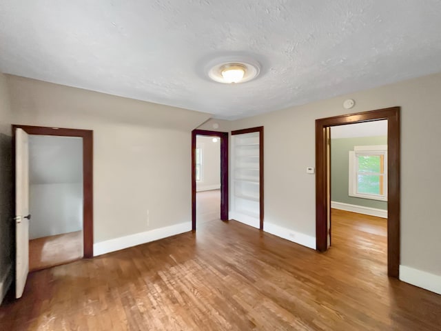 37 Caledonia St NE, Grand Rapids, MI 49505 - unfurnished room featuring wood finished floors and a textured ceiling