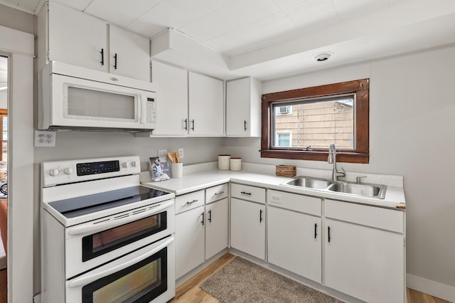 716 Price St, Saint Joseph, MI 49085 - kitchen with white appliances, light countertops, and white cabinetry