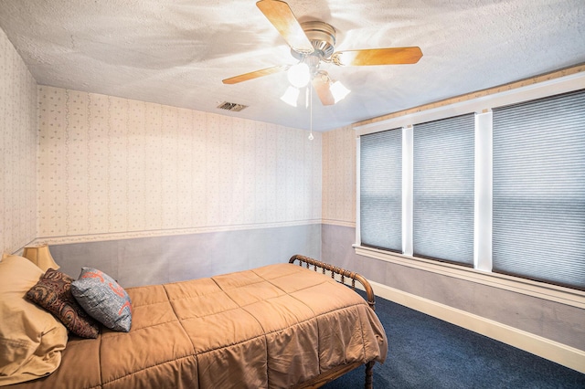 16 E Pine St, Fremont, MI 49412 - carpeted bedroom with wallpapered walls, a ceiling fan, and a textured ceiling