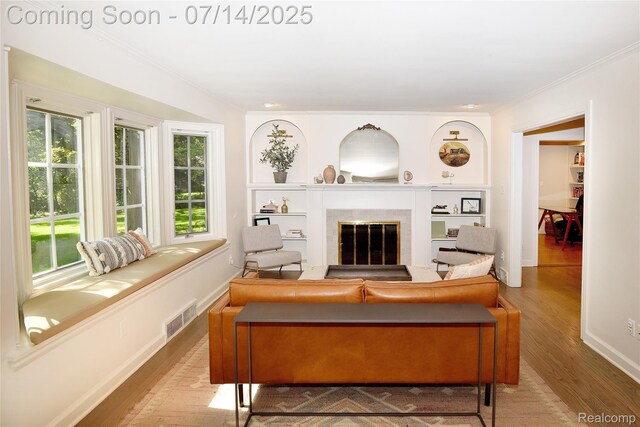 32965 Franklin Ct, Franklin, MI 48025 - living area with ornamental molding, wood finished floors, and a tile fireplace